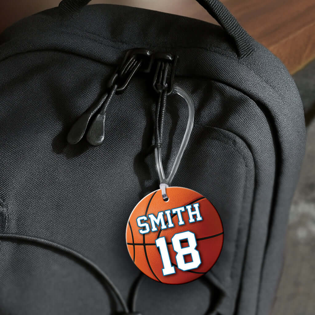 Personalized metal basketball hang tag ornament. 3.5″, includes name and number