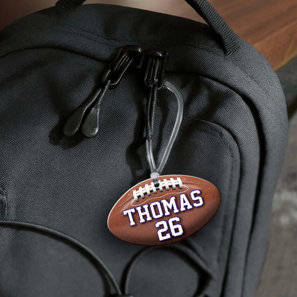 Personalized metal football hang tag ornament. 3.5″, includes name and number