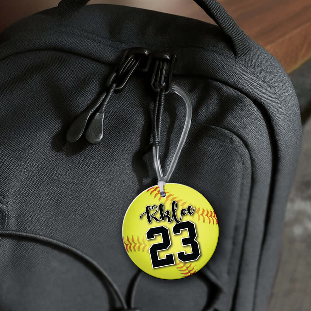 Personalized metal softball hang tag ornament. 3.5″, includes name and number