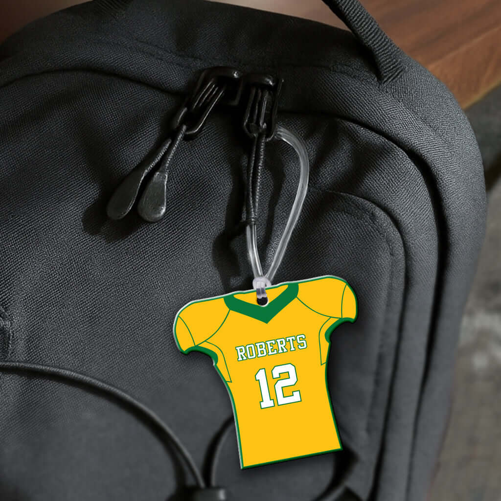 Personalized metal football jersey hang tag ornament. 3.5″, includes name and number